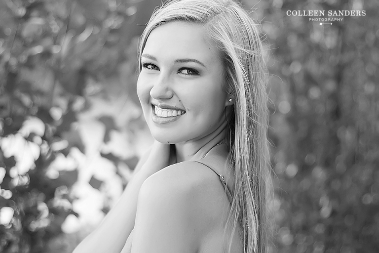 Classic high school senior portraits by the lake with natural greenery for my senior model by senior photographer Colleen Sanders near El Dorado Hills, California.