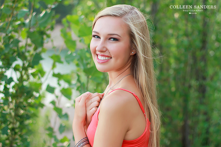Classic high school senior portraits by the lake with natural greenery for my senior model by senior photographer Colleen Sanders near El Dorado Hills, California.