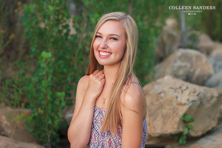Classic high school senior portraits by the lake with natural greenery for my senior model by senior photographer Colleen Sanders near El Dorado Hills, California.