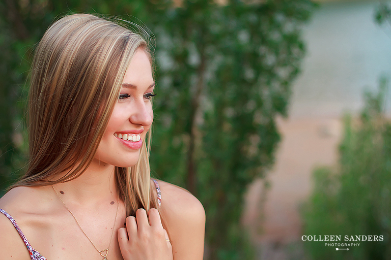 Classic high school senior portraits by the lake with natural greenery for my senior model by senior photographer Colleen Sanders near El Dorado Hills, California.