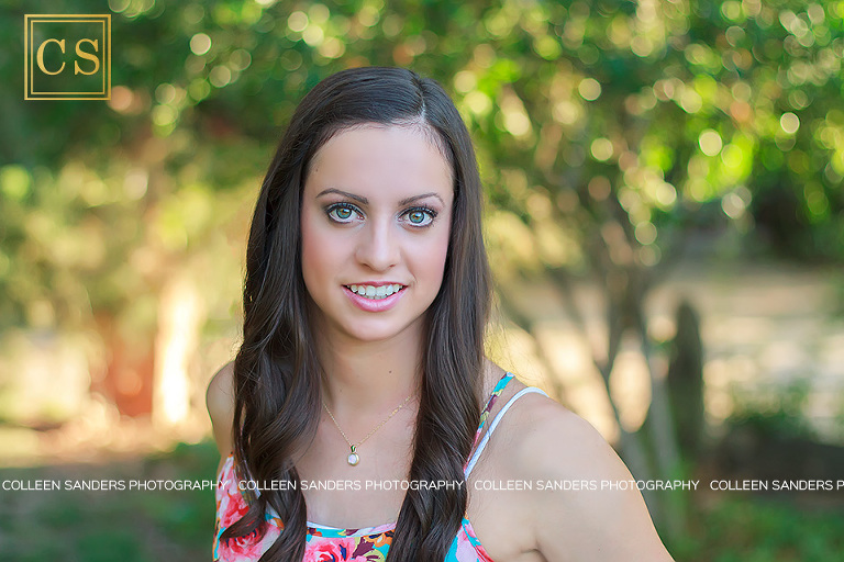 Nicole's senior portraits wearing a floral shirt, gorgeous back light and natural greenery and flowers in the summer by El Dorado Hills photographer Colleen Sanders.