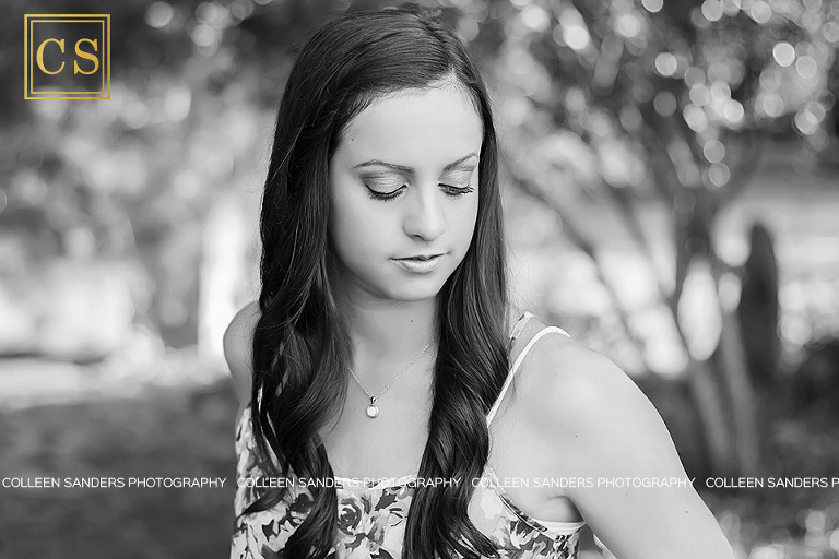 Senior portraits capturing Nicole's long eyelashes in black and white by senior photographer Colleen Sanders.