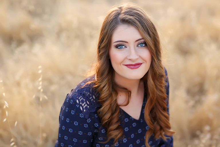 Senior from El Dorado High School in a filed at sunset, blue eyes, blue dress by El Dorado Hills Photographer Colleen Sanders.