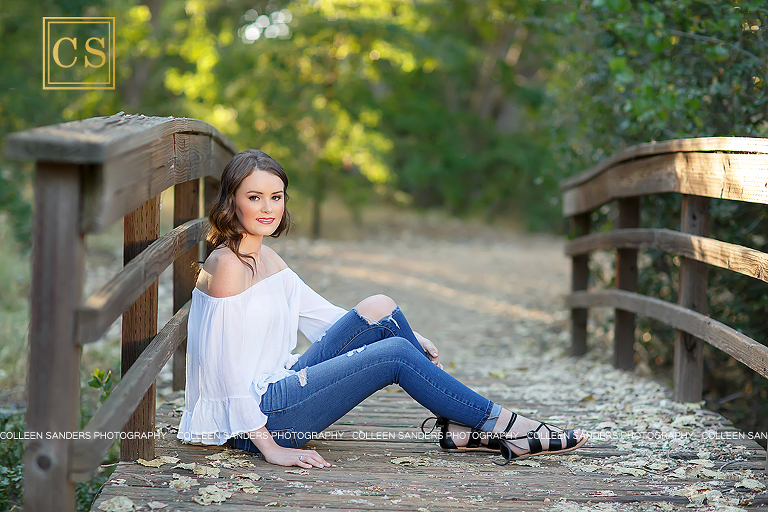 El Dorado Hills senior at Oak Ridge High School, natural greenery, with a hat, bridge, jeans and white shirt, girl, makeup. 