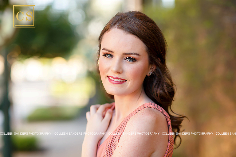 El Dorado Hills senior photographer Colleen Sanders shooting senior pictures for Oak Ridge Senior Lizzy in the El Dorado Hills Town center rose garden with her beautiful summer dress and makeup.