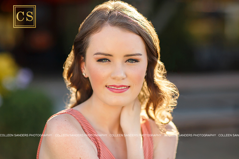 El Dorado Hills senior photographer Colleen Sanders shooting senior pictures for Oak Ridge Senior Lizzy in the El Dorado Hills Town center rose garden with her beautiful summer dress and makeup.