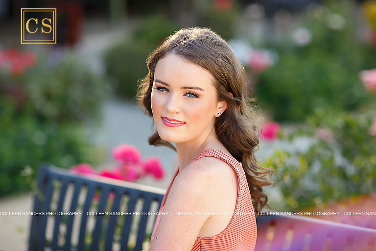 El Dorado Hills senior photographer Colleen Sanders shooting senior pictures for Oak Ridge Senior Lizzy in the El Dorado Hills Town center rose garden with her beautiful summer dress and makeup.