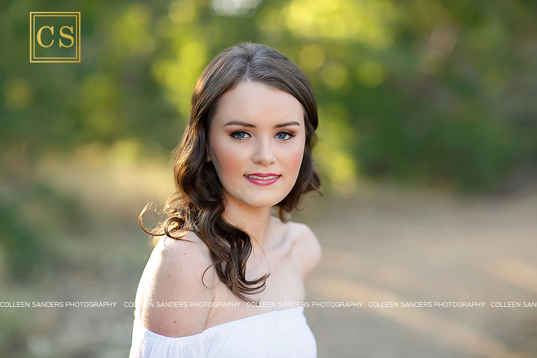 El Dorado Hills senior at Oak Ridge High School, natural greenery, with a hat, bridge, jeans and white shirt, girl, makeup. 