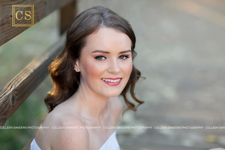 El Dorado Hills senior at Oak Ridge High School, natural greenery, with a hat, bridge, jeans and white shirt, girl, makeup. 