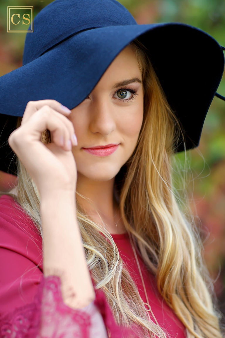 Colleen Sanders Photography senior pictures girl red dress, gold jewelry, hat, fall portraits, closeup eye detail.